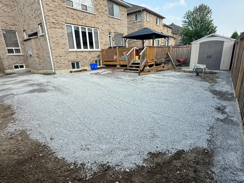 Granular base spread and compacted flat across a backyard