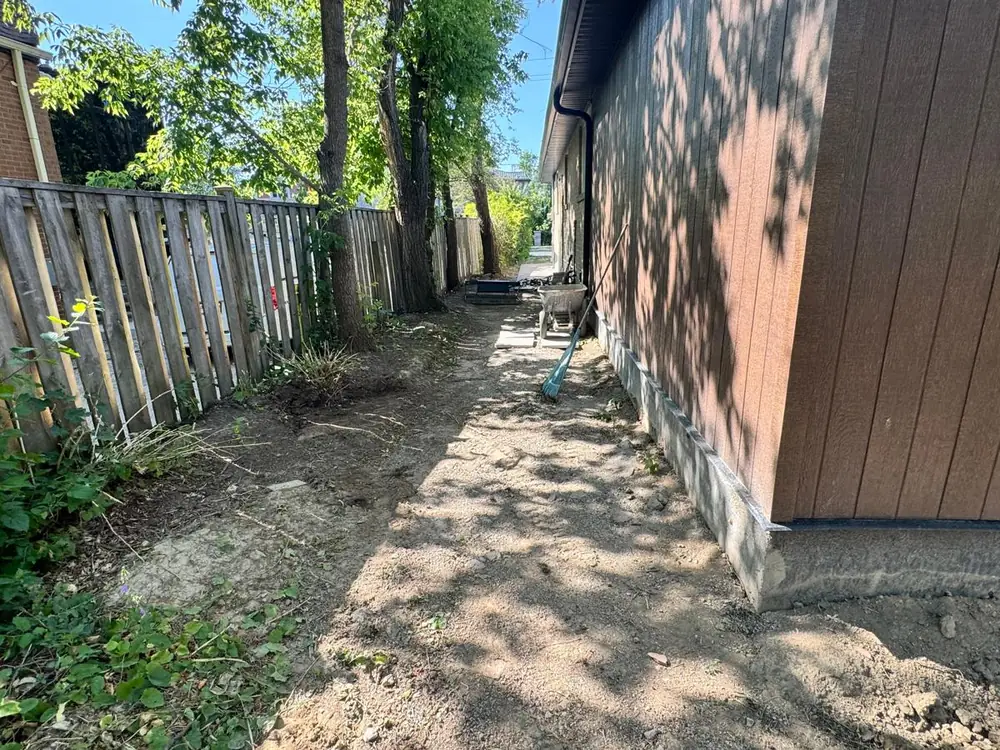 Bare dirt run beside the house before work started